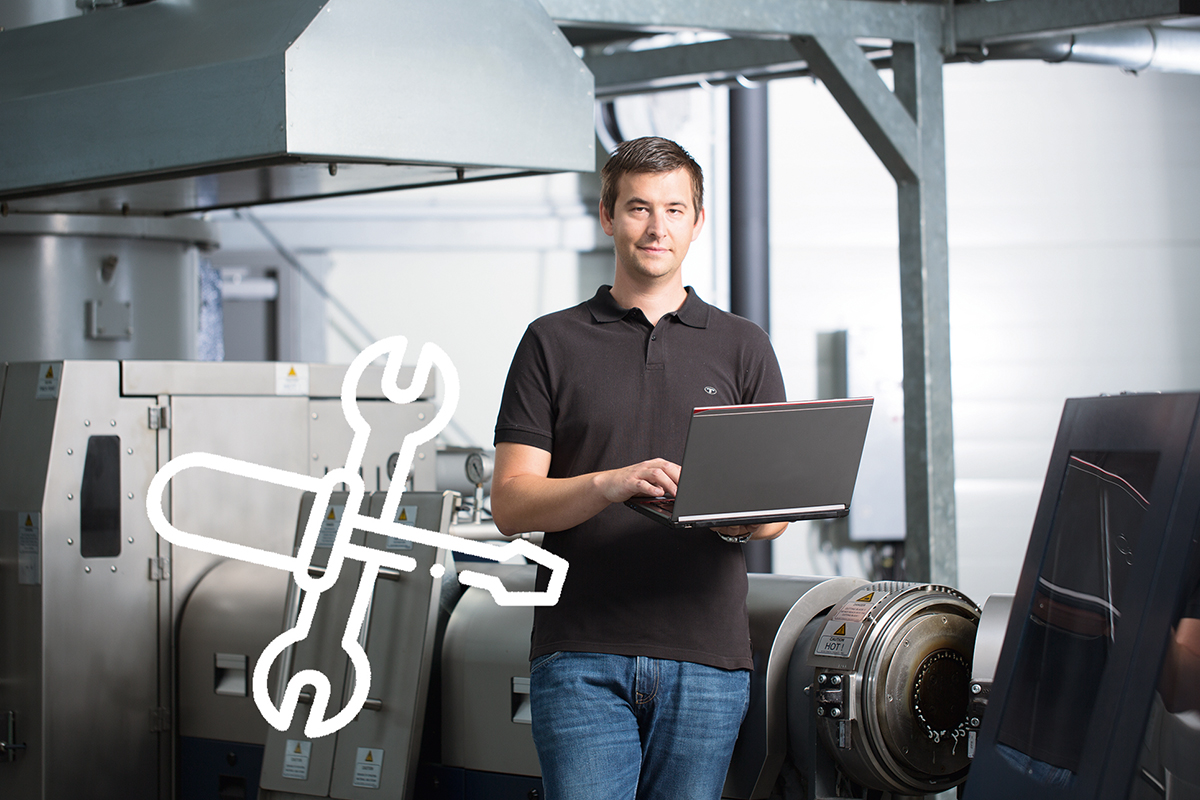PURE LOOP employee next to the plastic recycling equipment