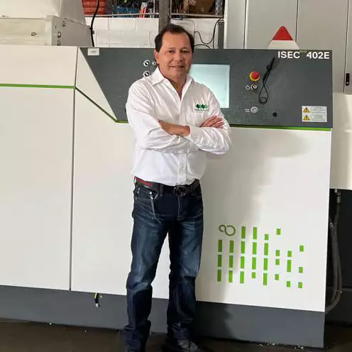 Axel Rivera in front of the pelletizing machine 